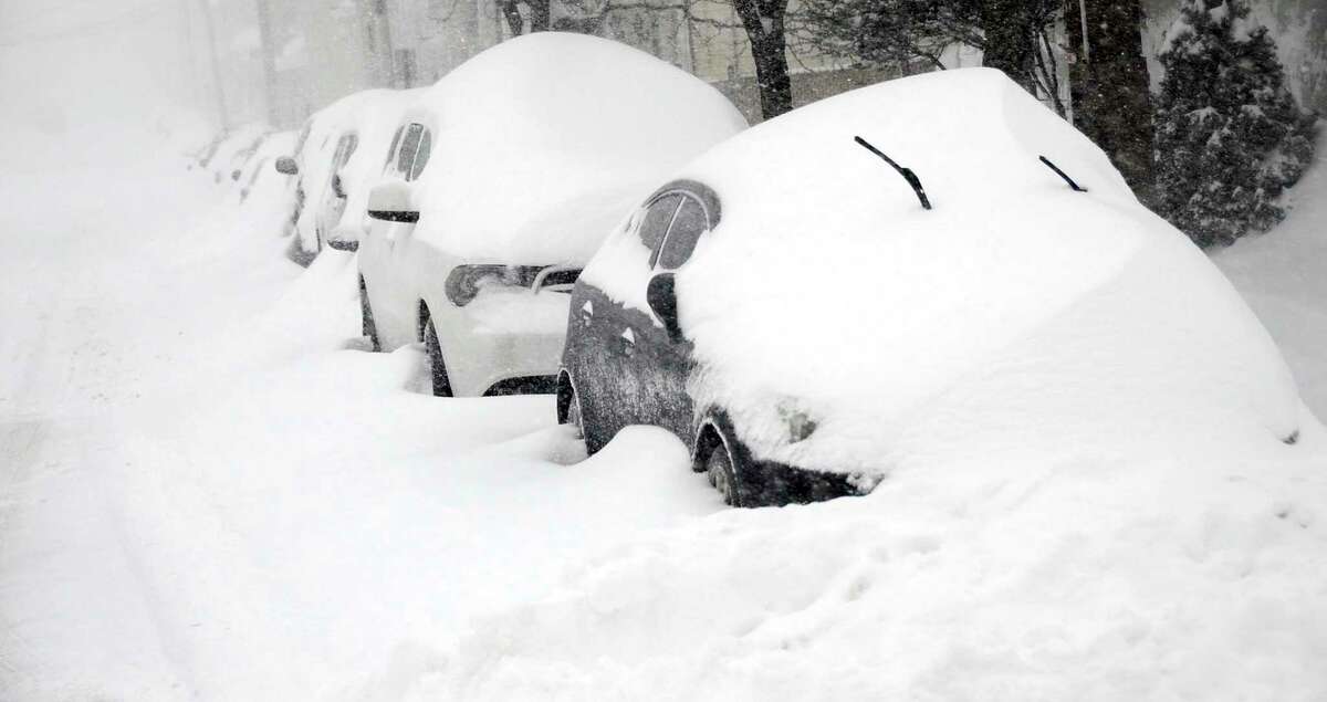 Cars parked on East Green Street in Hazleton, Pa., are buried as heavy snowfall moves through the area leaving more than a foot of snow, Tuesday, March 14, 2017. More than 30 inches of snow is expected to accumulate before the winter storm moves out. (Ellen F. O'Connell/Hazleton Standard-Speaker via AP)