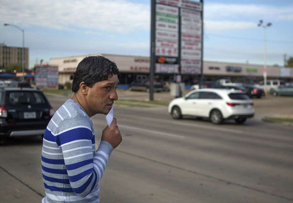 Shaor Ahmad Safi crosses Hillcroft Avenue to cash his one-time $800 "welcome money" check he just received from the Alliance for Multicultural Community Services, an agency of United Way, Thursday, Dec. 1, 2016, in Houston. Shaor, who just immigrated to the United States two weeks ago, worked as a translator for the U.S. military in the Kandahar Province of Afghanistan accompanying American soldiers on patrols through the mountains. ( Mark Mulligan / Houston Chronicle )