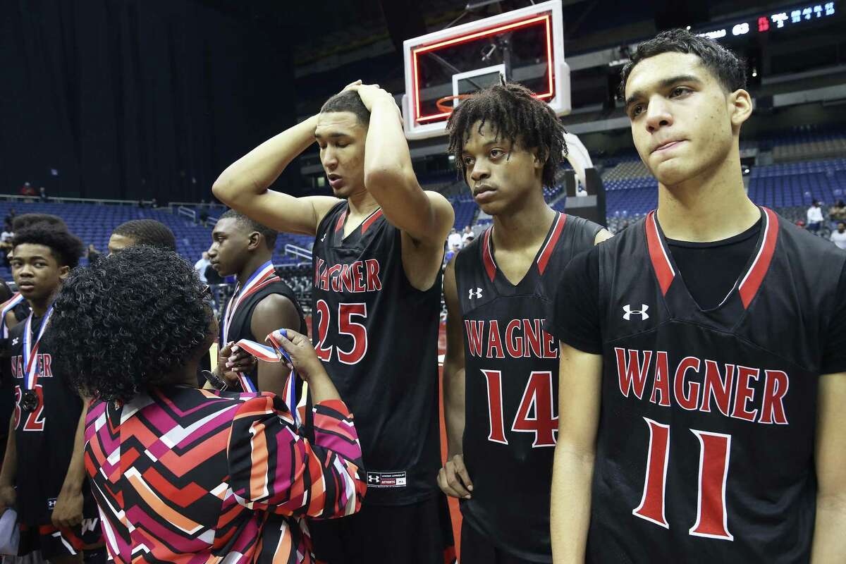 Tristan Clark receives his medal after Wagner loses to the Cypress Falls Eagles in the state championship basketball game for class 6A boys at the Alamodome on March 11, 2017.