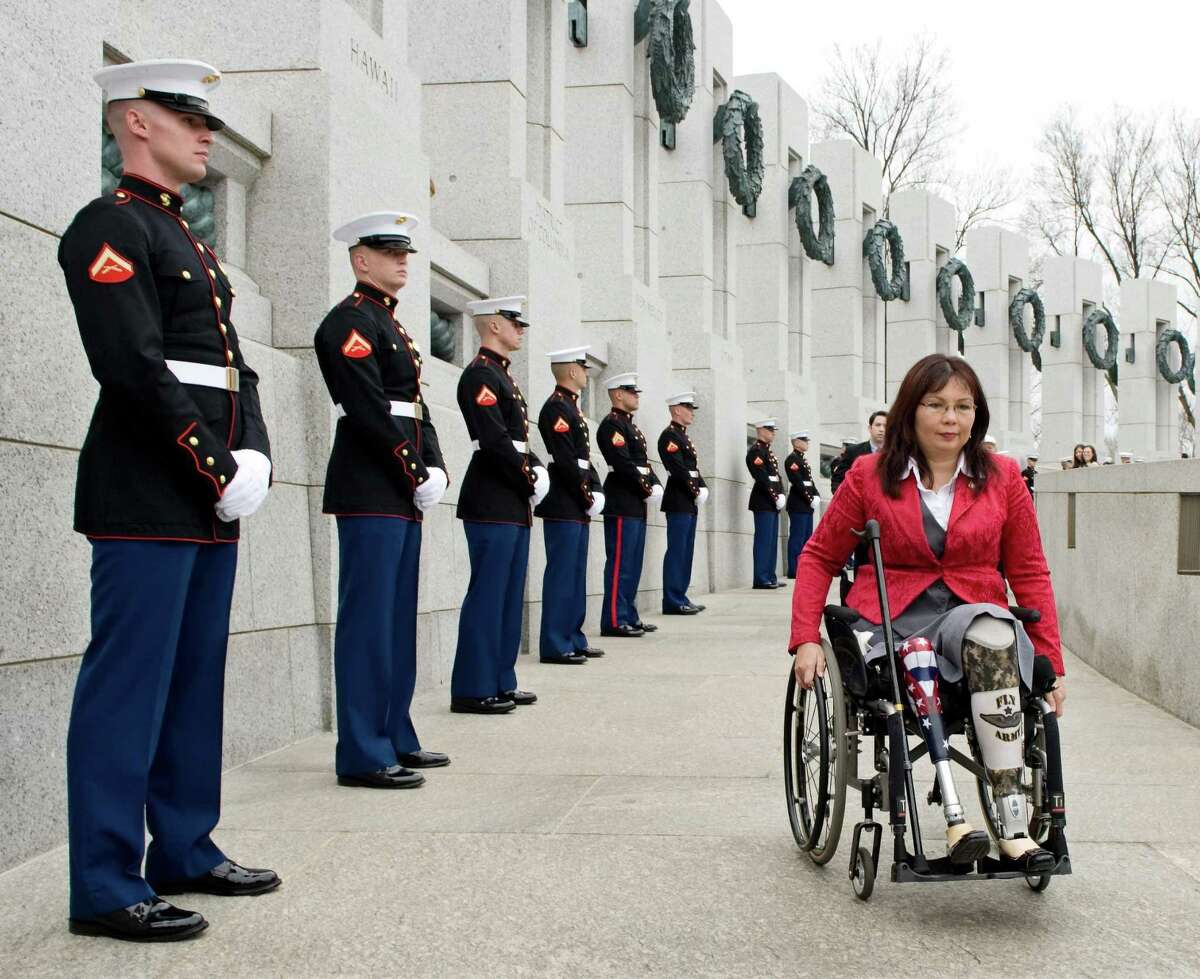 FILE - In this Thursday, March 11, 2010 file photo, Tammy Duckworth, assistant secretary for the U.S. Department of Veterans Affairs, arrives at the World War II Memorial in Washington for a ceremony honoring World War II veterans who fought in the Pacific. Duckworth, who is running in 2012 as a congressional candidate in Illinois, became a double amputee when her National Guard helicopter was shot down in Iraq in 2004. During the long wars in Afghanistan and Iraq, hundreds of thousands of veterans have come home and laid aside their uniforms. But not all have opted to simply blend back into civilian life. Many have chosen to run for public office. (AP Photo/Cliff Owen)