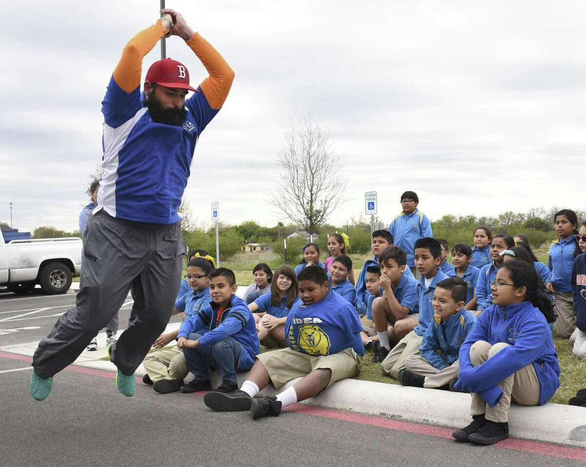 Physical education teacher David Alfaro demonstrates broad jump technique during physical education class at IDEA Monterrey Park on Friday, March 3, 2017. The "Healthy Kids Here" initiative aims to encourage students to achieve and maintain good health.
