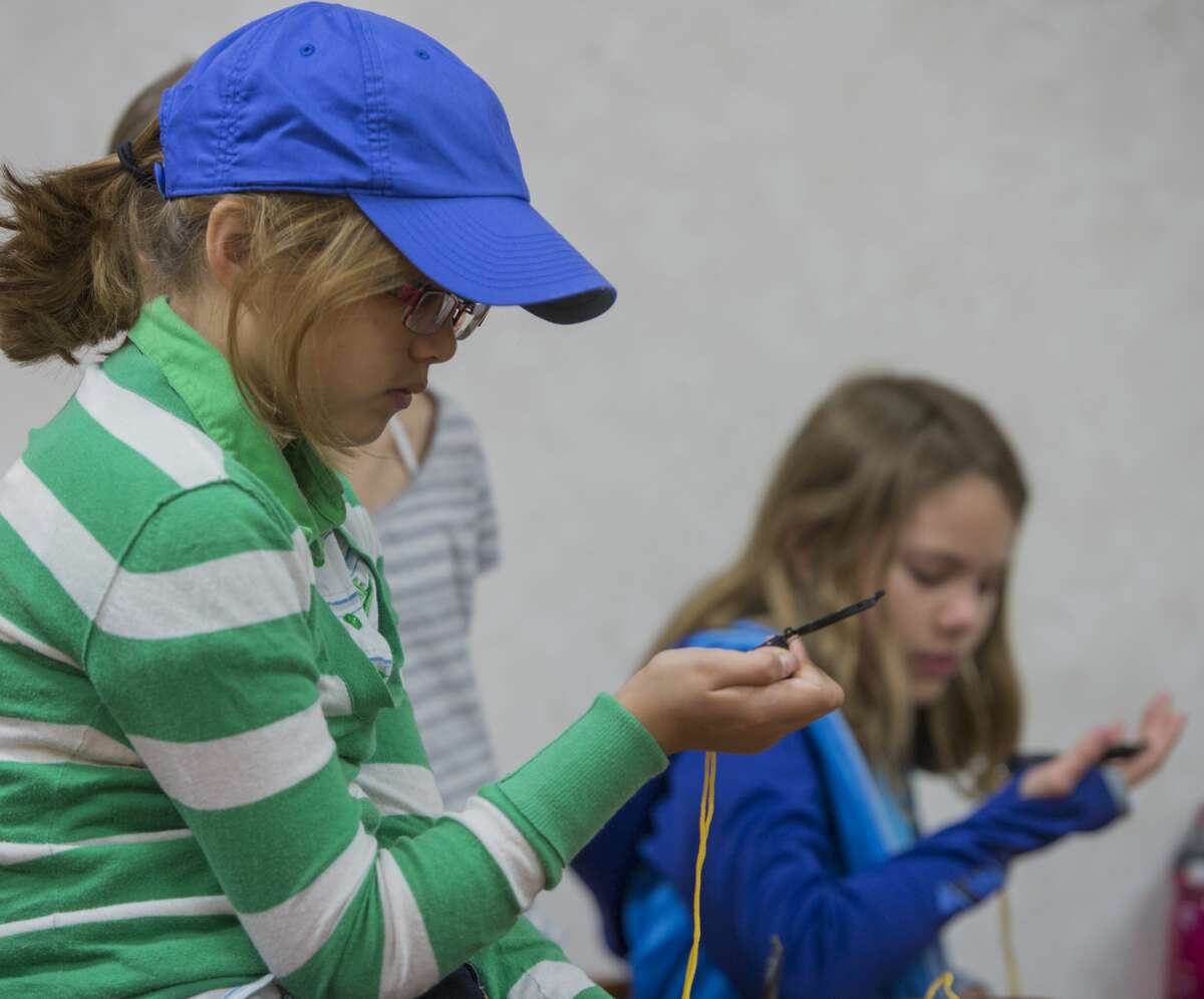 Lauren Escamilla and other students practice using a compass 03-14-17 during the Sibley Nature Center Spring Break Camp. Tim Fischer/Reporter-Telegram