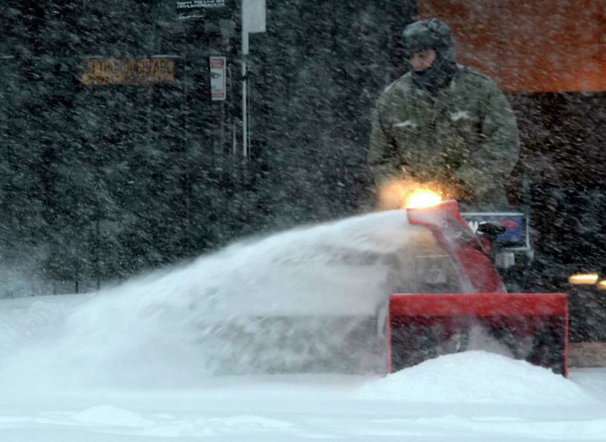 A worker moves the heavy snow from a winter storm on Washington Avenue on Tuesday, March 14, 2017, in Albany, N.Y. (Skip Dickstein/Times Union)