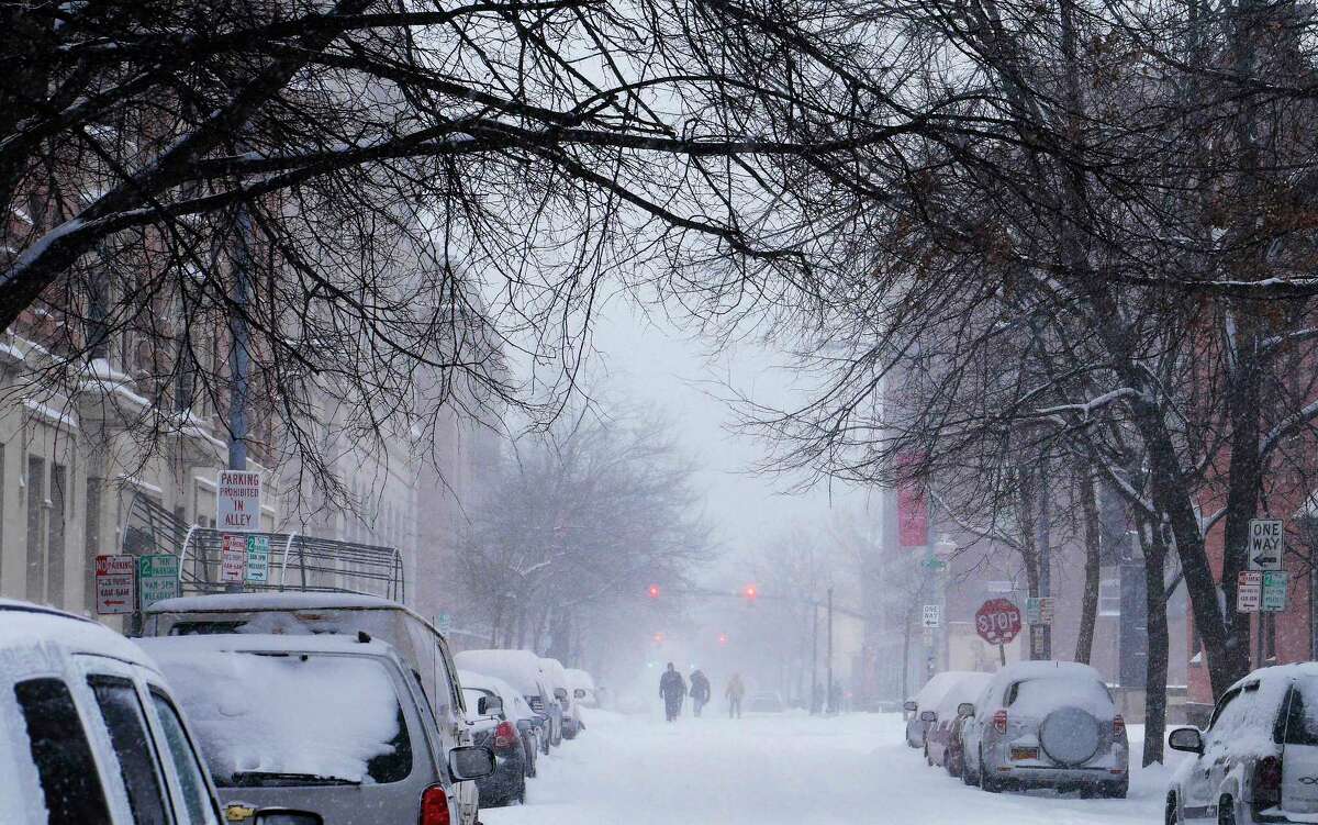 People forgo the snow covered sidewalks and walk in the streets on Tuesday, March 14, 2017, in Troy, N.Y. (Paul Buckowski / Times Union)