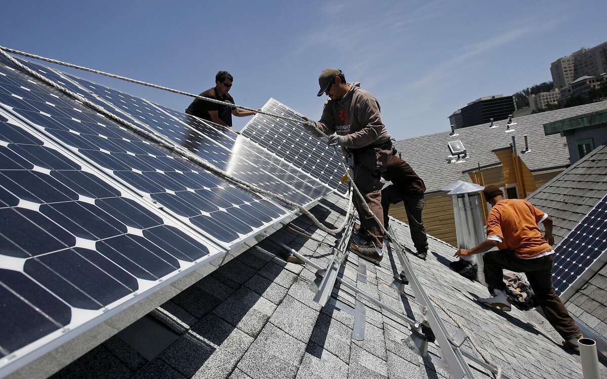 A Sungevity crew installs solar panels on the roof of a home in San Francisco on May 14, 2009.