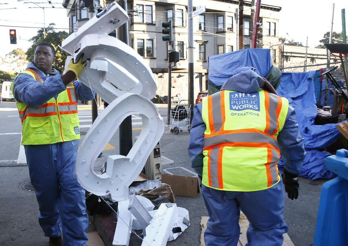 A Public Works Hot Spots crew clears out a homeless encampment at 14th and Mission streets before sanitizing the sidewalk in San Francisco, Calif. on Tuesday, March 14, 2017.
