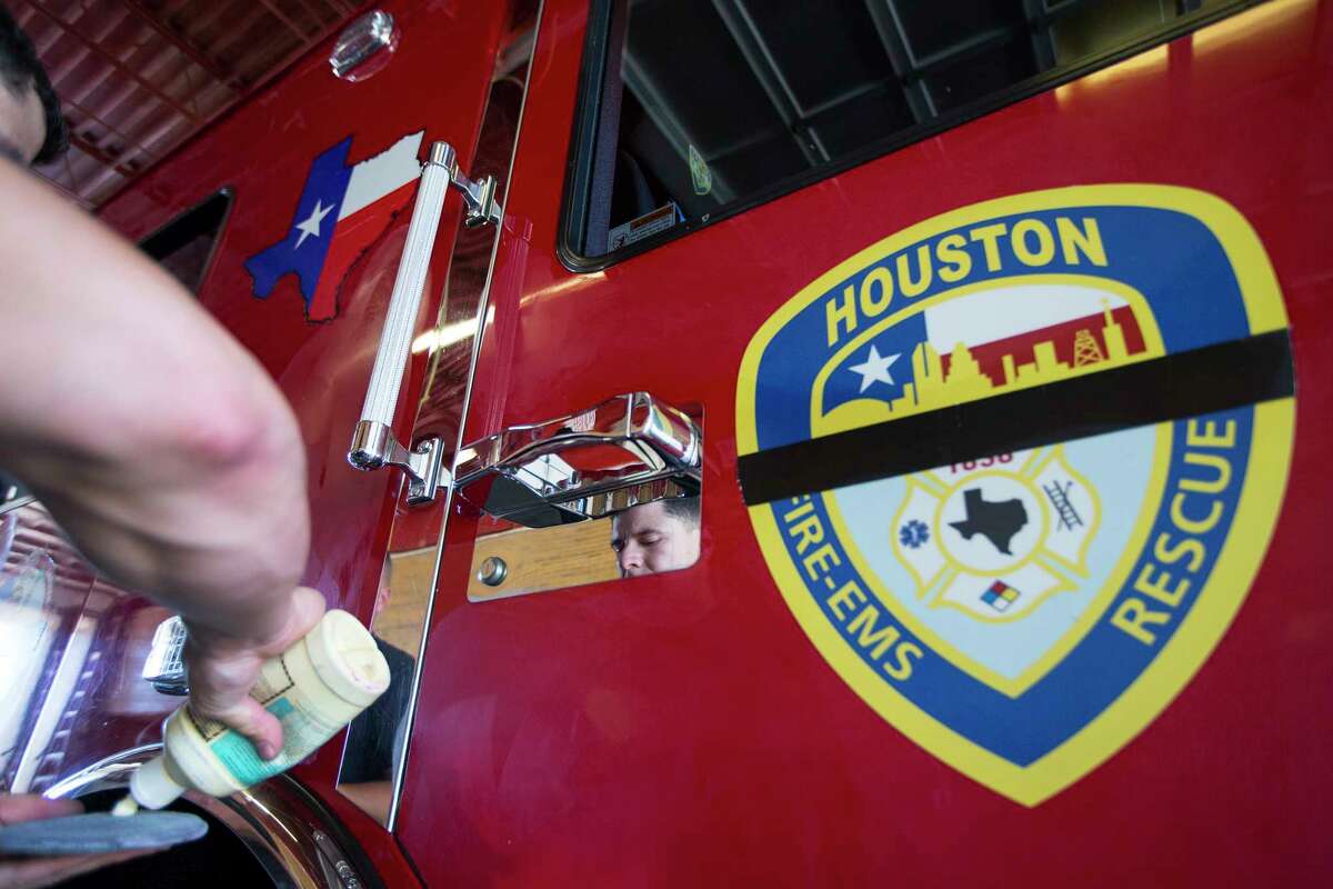 Houston firefighter Chris Hernandez waxes HFD Ladder 68 as he helps prepare it for the public memorial service for Houston Fire Capt. William "Iron Bill" Dowling on Tuesday, March 14, 2017, in Houston.