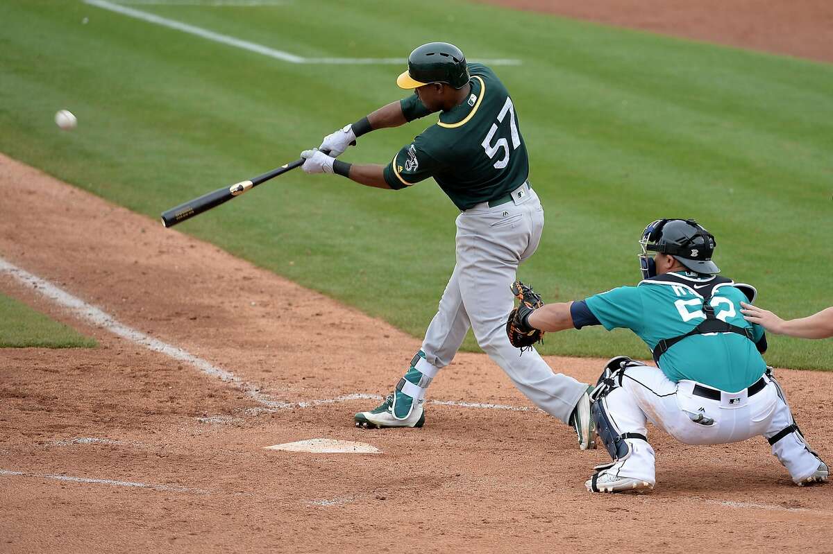 PEORIA, AZ - MARCH 05: Alejandro De Aza #57 of the Oakland Athletics hits an RBI double in the fifth inning of the spring training game against the Seattle Mariners at Peoria Stadium on March 5, 2017 in Peoria, Arizona. (Photo by Jennifer Stewart/Getty Images)