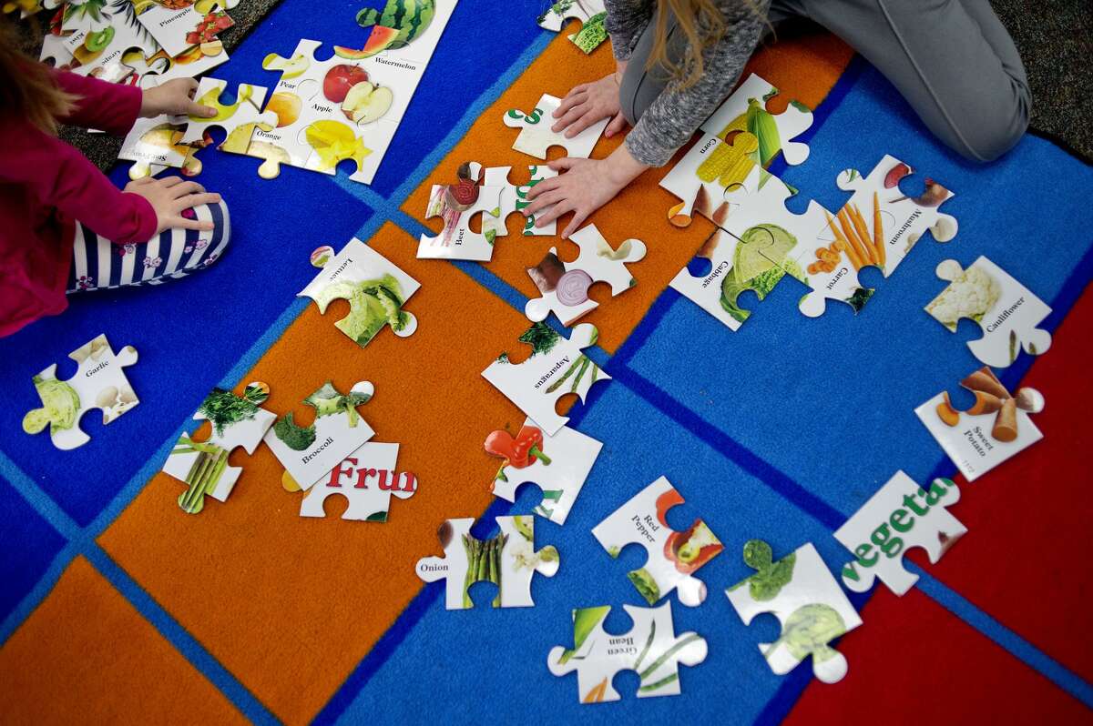 Kindergartners work on fruit and vegetables puzzles as part of the AgKindergarten program on Monday at Coleman Elementary School. The program provides students an understanding of Agriculture and other STEM skills at a young age. An $8000 grant through the Community Foundation Dow Corning Funding helped get the program off the ground.