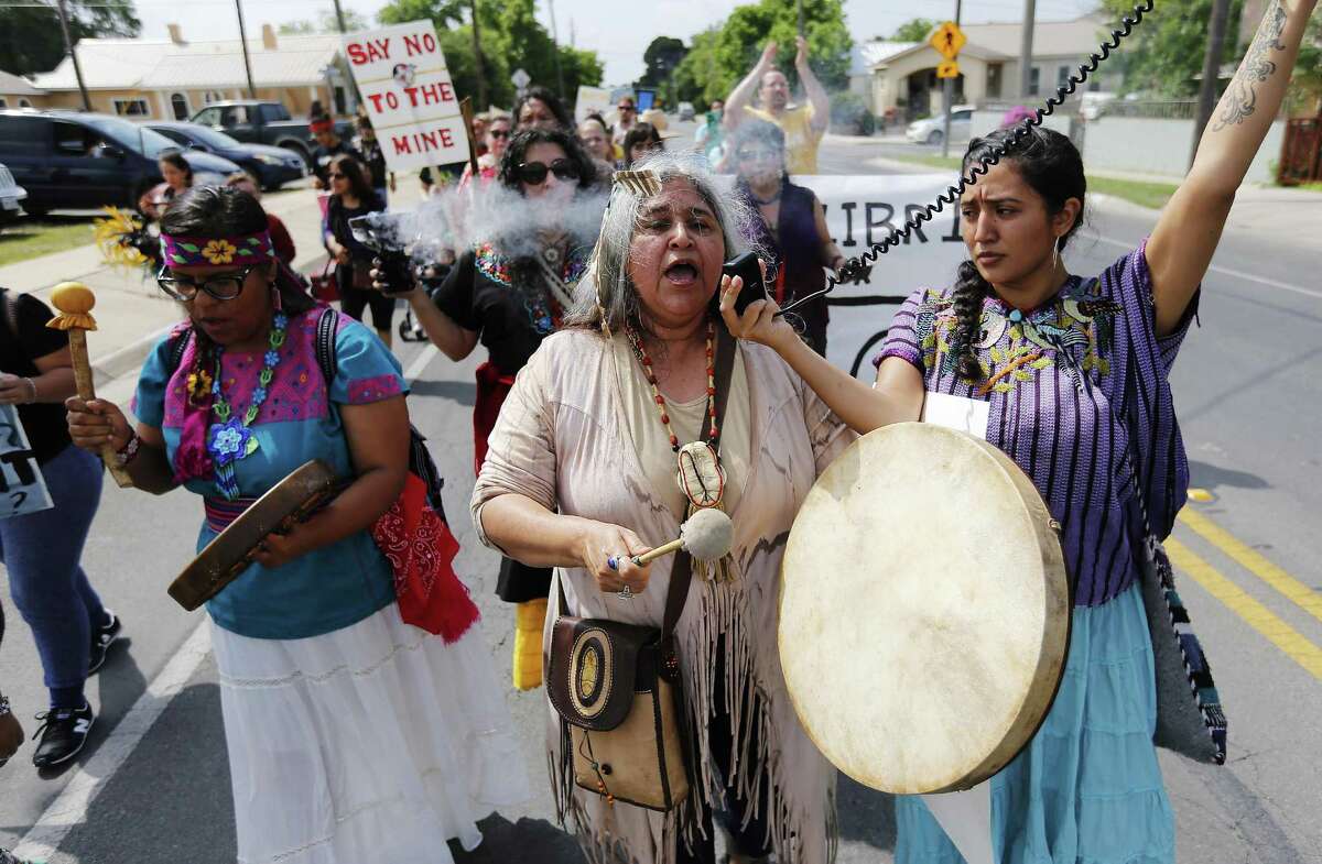 Yvette Mendez (center) with Edyka Chilome (right) and Marlene Villanueva of Alma de Mujer participate in a protest march against a coal mine operation in Eagle Pass, Texas on Saturday, Apr. 16, 2016. Native American tribes have joined environmentalists in a fight against a Dos Republicas coal mine in Eagle Pass with a nine-mile protest march to the coal mine on the outskirts of town. Despite delays by the opposition, the mine started operating last year producing high-sulfur coal and shipping the coal to a parent-company plant in Mexico to burn. Nearly 150 protestors started in Shelby Park near the U.S.-Mexico border in Eagle Pass and made an hours-long trek to the plant to once again voice their opposition. They cite the plants lack of environmental concerns, the lack of economic development and the lack of oversite by the Native American groups as several of the issues they protestors have with the coal mine operators. (Kin Man Hui/San Antonio Express-News)