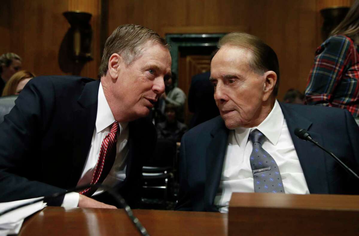 United States Trade Representative-nominee Robert Lighthizer, left, talks to former Sen Bob Dole, R-Kan., during his confirmation hearing on Capitol Hill in Washington, Tuesday, March 14, 2017. President Donald Trump's pick to represent the country in trade negotiations says the U.S. should have an "America first trade policy." (AP Photo/Manuel Balce Ceneta)