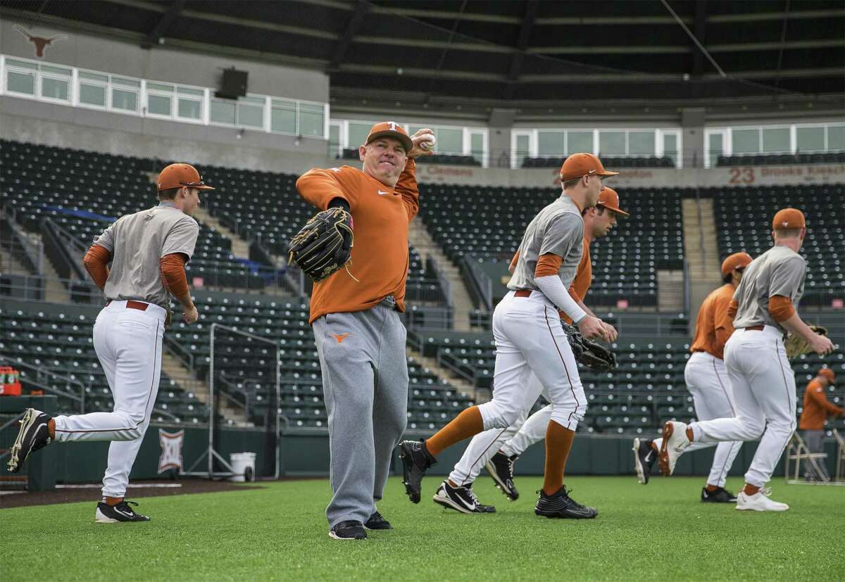 Texas coach David Pierce warms up during the first practice the season at UFCU Disch-Falk Field in Austin on Jan. 27, 2017.