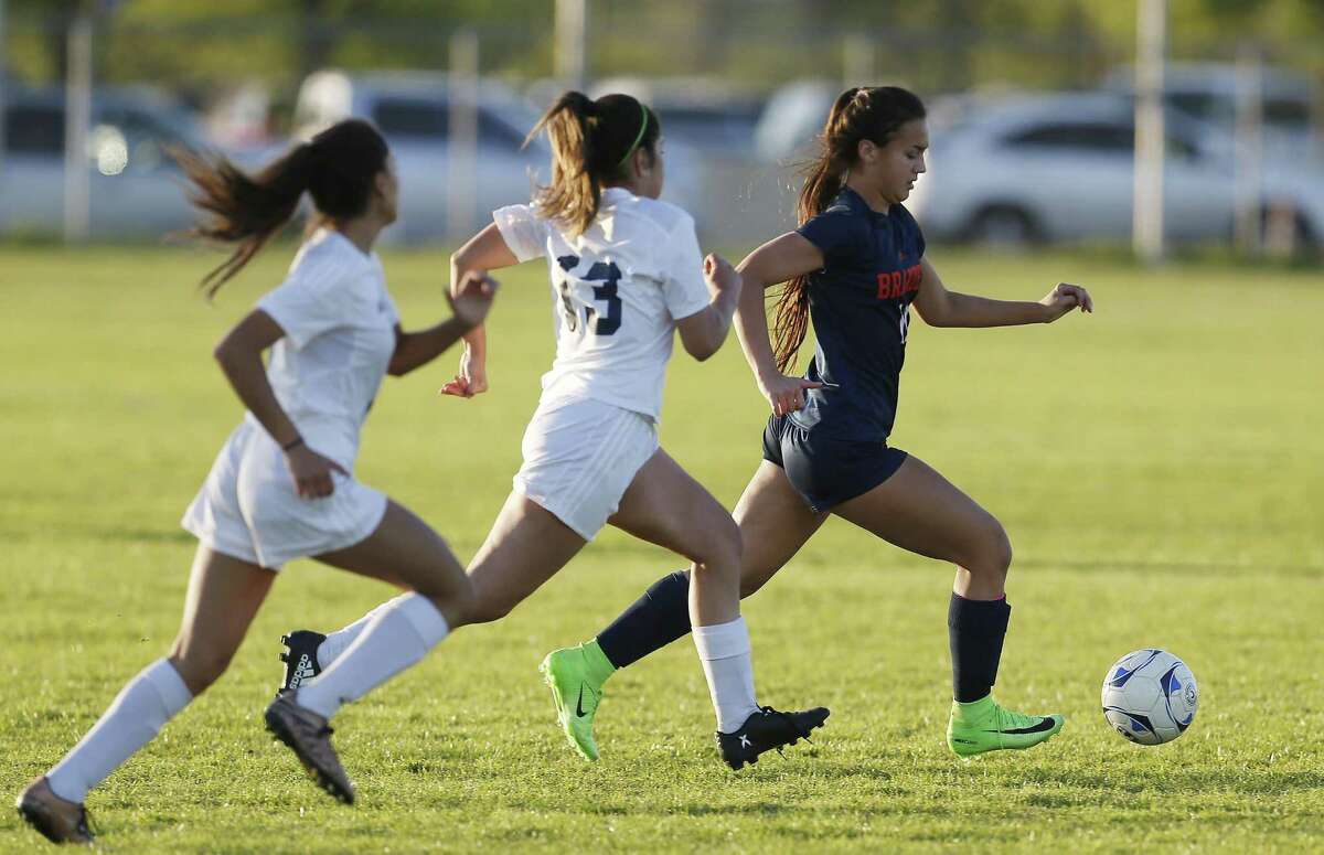 Brandeis’ Samantha Palomino (right) pushes ahead of two Jay defenders in girls soccer at Northside Athletic Complex on March 14, 2017.