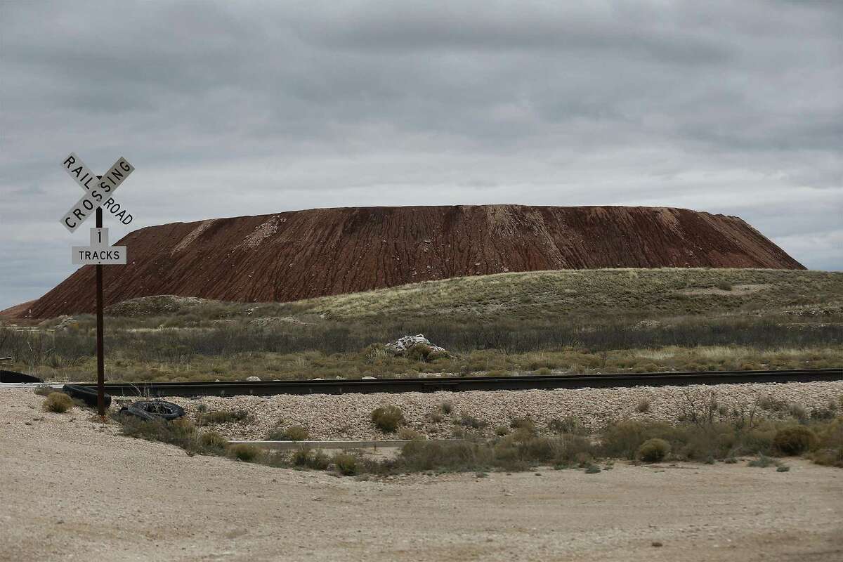 A view of a large mound of Dockum clay that is used at Waste Control Specialists (WCS) near Andrews, Texas, as part of the encasement for spent nuclear waste at its facility. WCS provides services to store low-level nuclear waste already and is applying to store more dangerous high-level radioactive waste.