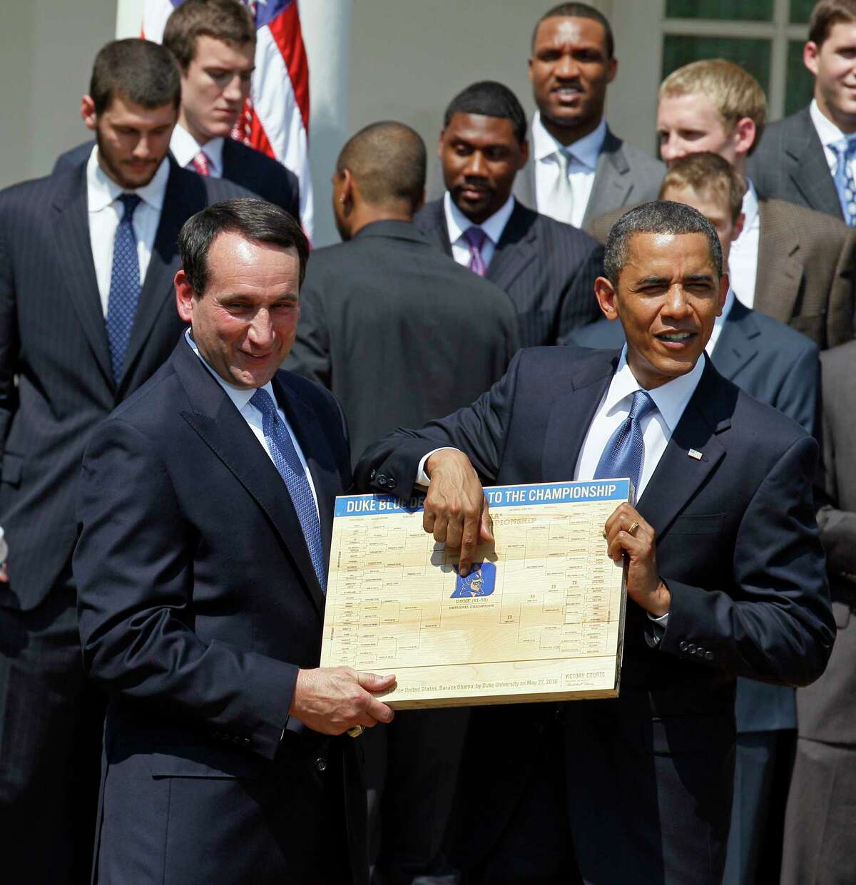 FILE - In this May 27, 2010 file photo, President Barack Obama looks over the bracket with Duke University basketball Coach Mike Krzyzewski in the Rose Garden of the White House in Washington, where he honored the team. From his campaign fist bump to his theatrical mic drop at the last White House correspondents’ dinner, Barack Obama ruled as America’s pop culture president. His two terms played out like a running chronicle of the trends of our times: slow-jamming the news with Jimmy Fallon, reading mean tweets with Jimmy Kimmel, filling out his NCAA basketball bracket on ESPN, cruising with Jerry Seinfeld on “Comedians in Cars Getting Coffee.” (AP Photo/Alex Brandon, File)