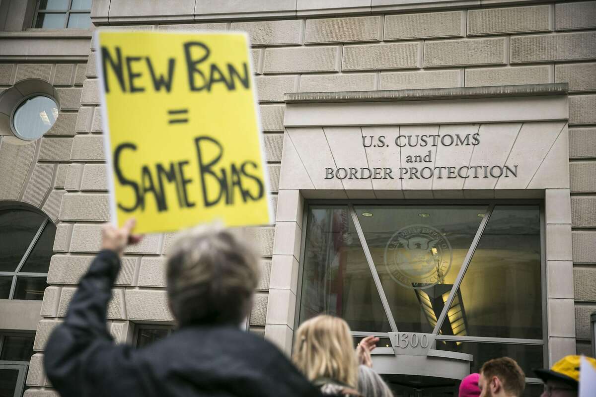 FILE -- Protesters demonstrate against President Donald Trump�s revised travel ban, outside the U.S. Customs and Border Protection headquarters in Washington, March 7, 2017. Trump�s new executive order sharply restricting travel from the Middle East is set to go into effect just after midnight Thursday, even as the measure faces an array of legal challenges from nonprofit groups and Democratic state attorneys general.(Al Drago/The New York Times)