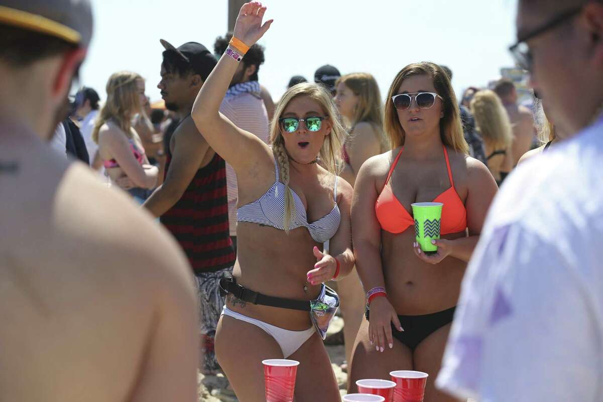 Amber Braun, 22, left, and Payton Holtmeyer, 21, students at Lincoln University of Missouri, play beer pong at Clayton's Beach Bar and Grill in South Padre Island, Tuesday, March 14, 2017. Spring Break brings thousands of visitors to the island and last year, sales revenues grossed $30.5 million.