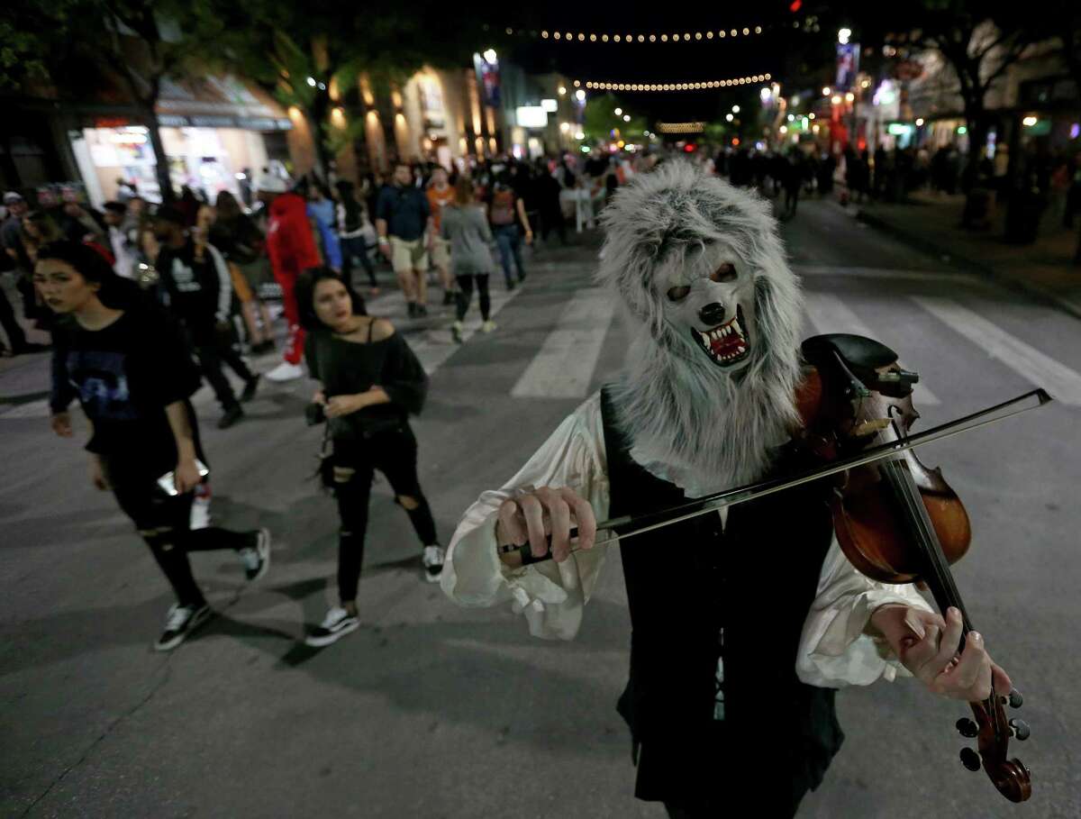 The "Violin Monster" performs on 6th Street Wednesday March 15, 2017 in Austin during SXSW.