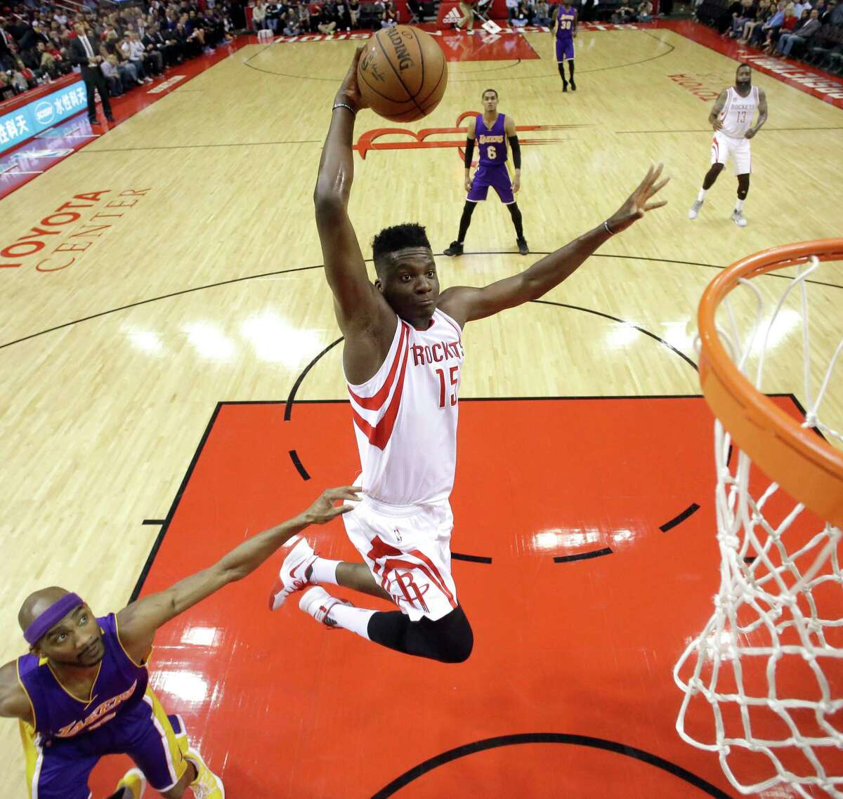 Houston Rockets' Clint Capela (15) goes up to dunk as Los Angeles Lakers' Corey Brewer defends during the first half of an NBA basketball game Wednesday, March 15, 2017, in Houston. (AP Photo/David J. Phillip)