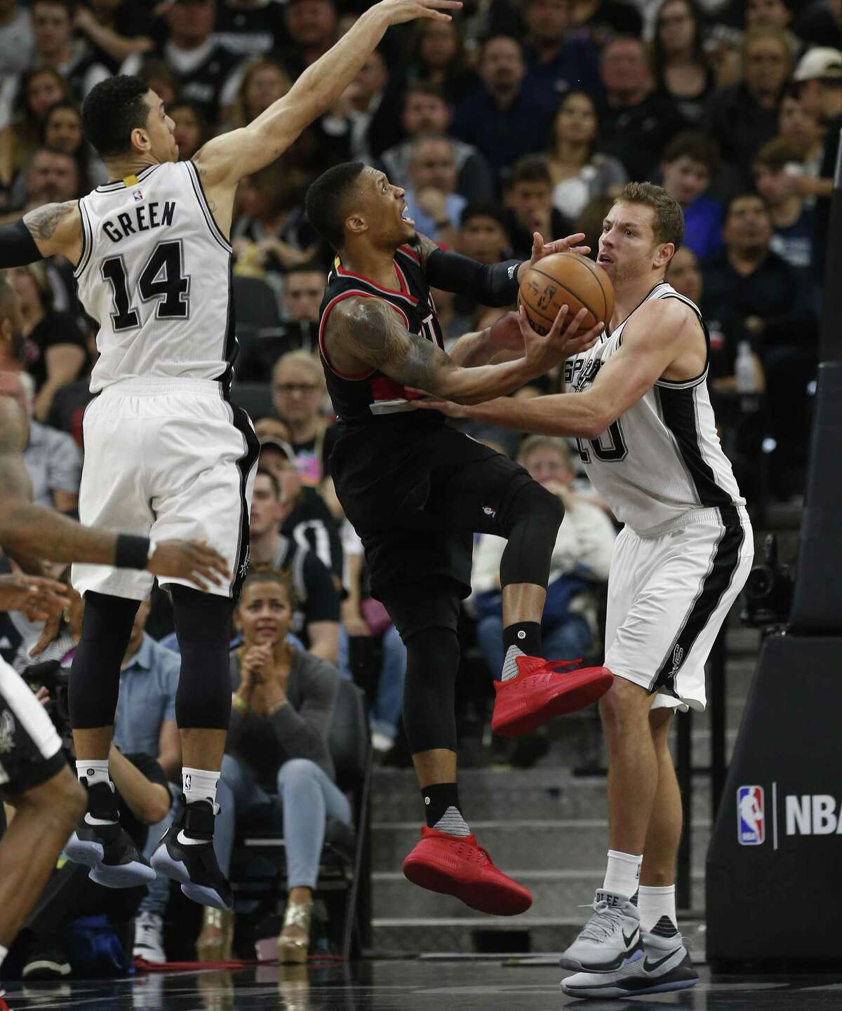 Spurs' Danny Green (14) and David Lee (10) defend against Portland Trailblazers' Damian Lillard (00) during their game at the AT&T Center on Wednesday, Mar. 15, 2017. Trailblazers defeated the Spurs, 110-106. (Kin Man Hui/San Antonio Express-News)