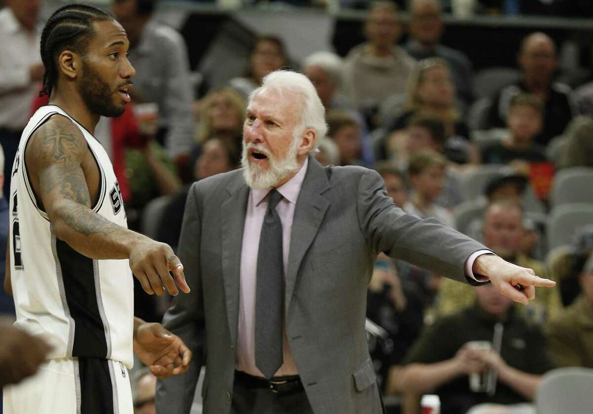 Spurs head coach Gregg Popovich tells Kawhi Leonard what happened on a play against the Portland Trail Blazers during their game at the AT&T Center on March 15.