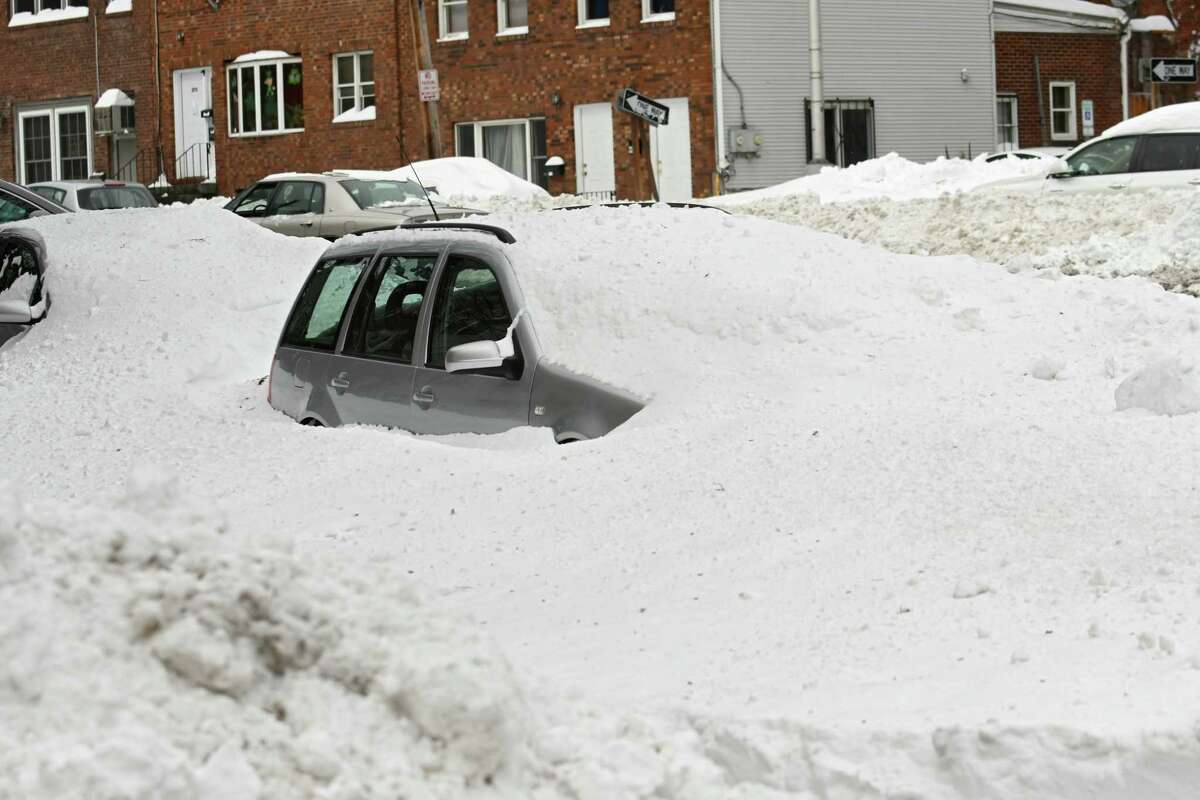 Cars are seen buried in snow from yesterday's snow storm on Washington Ave. on Wednesday, March 15, 2017 in Albany, N.Y. (Lori Van Buren / Times Union)
