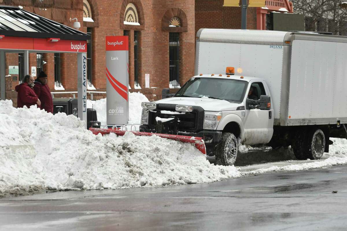 A truck plows snow from yesterday's snow storm in front of a bus stop near the Washington Armory on Washington Ave. on Wednesday, March 15, 2017 in Albany, N.Y. (Lori Van Buren / Times Union)