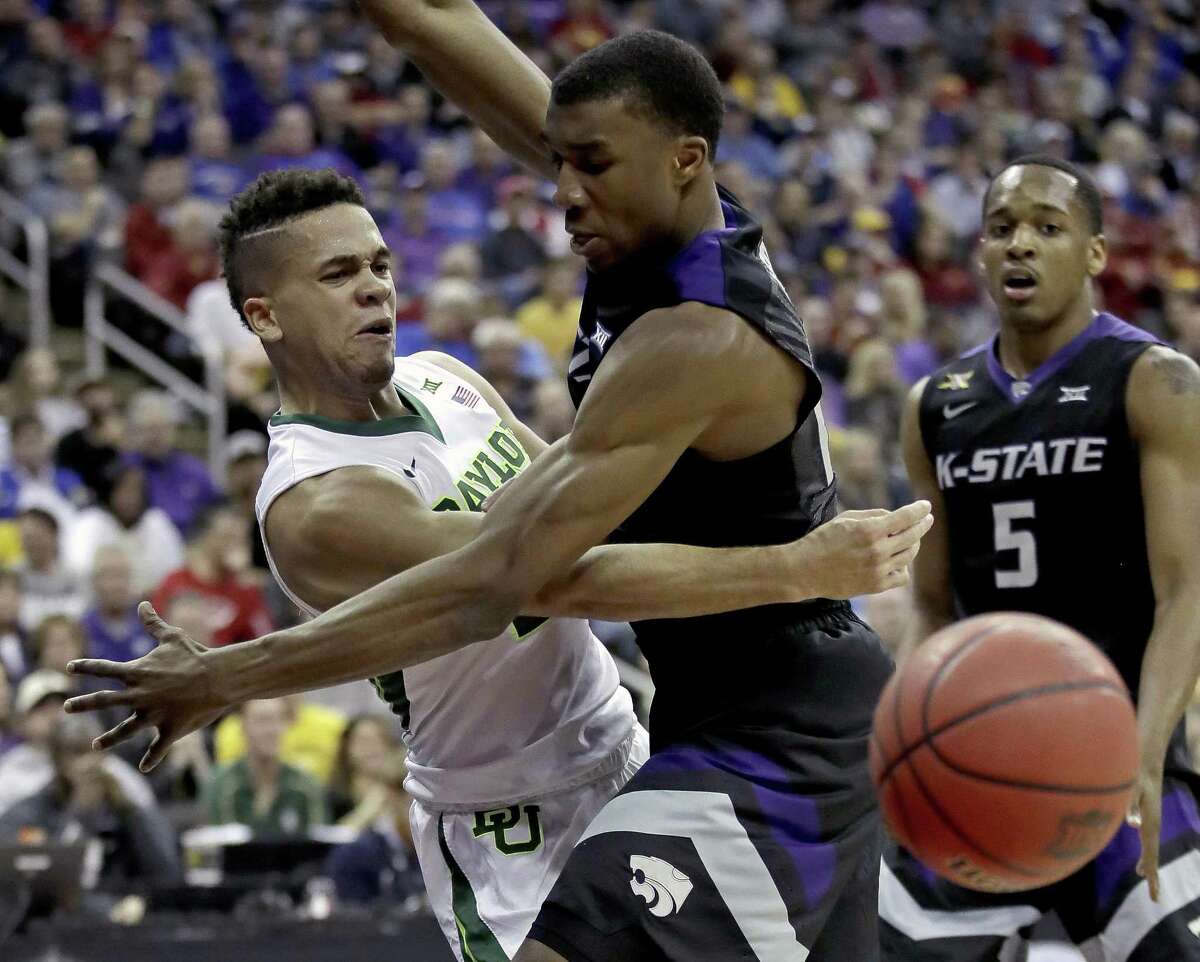 Baylor’s Manu Lecomte (left) passes around Kansas State’s Xavier Sneed during the first half of a quarterfinal round game at the Big 12 tournament in Kansas City, Mo., on March 9, 2017.
