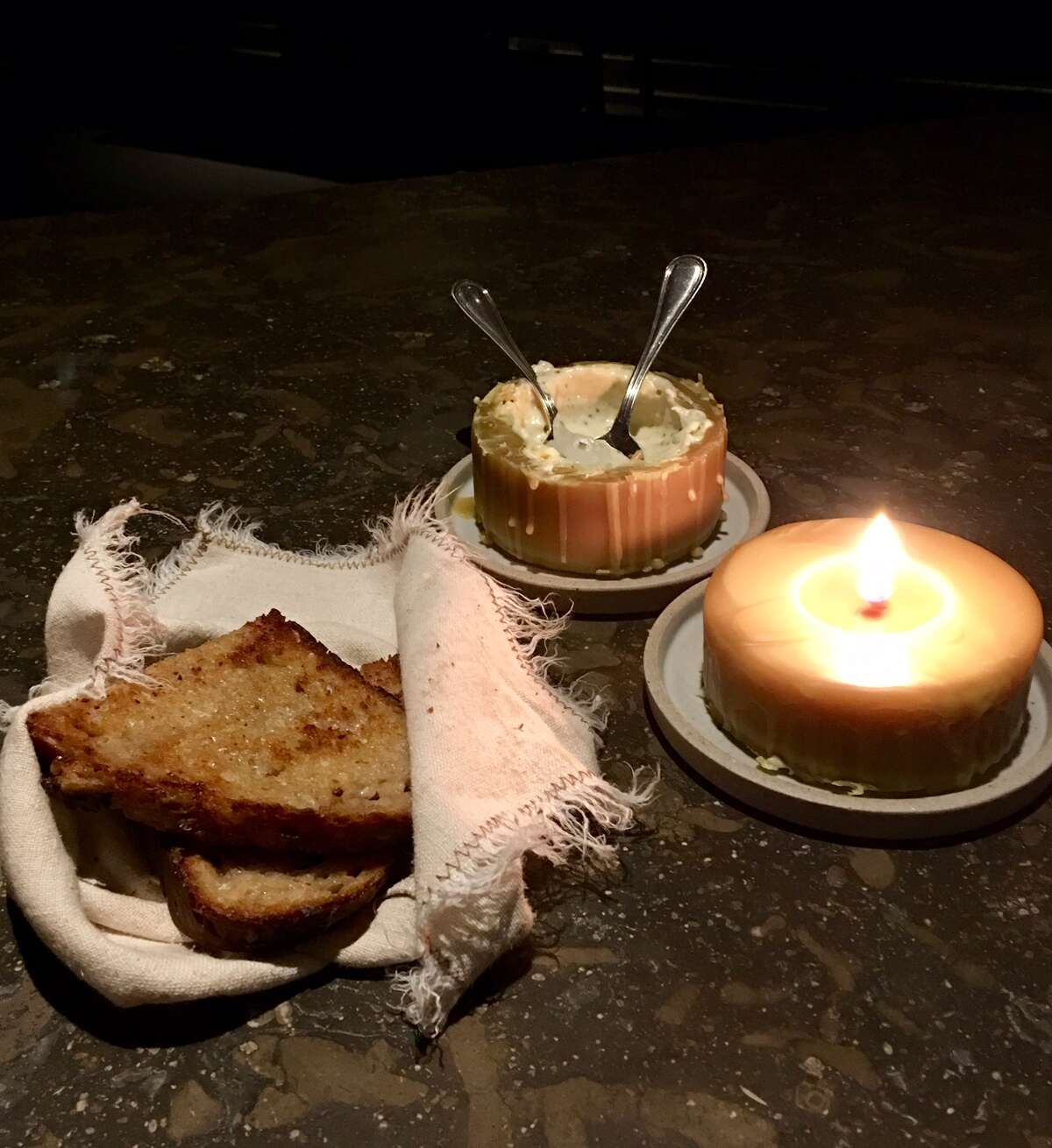 Restaurant at Meadowood, St. Helena: One of the most surprising courses is the cheese that's locked inside a candle. The waiter cuts the candle in two to reveal the creamy warm cheese.