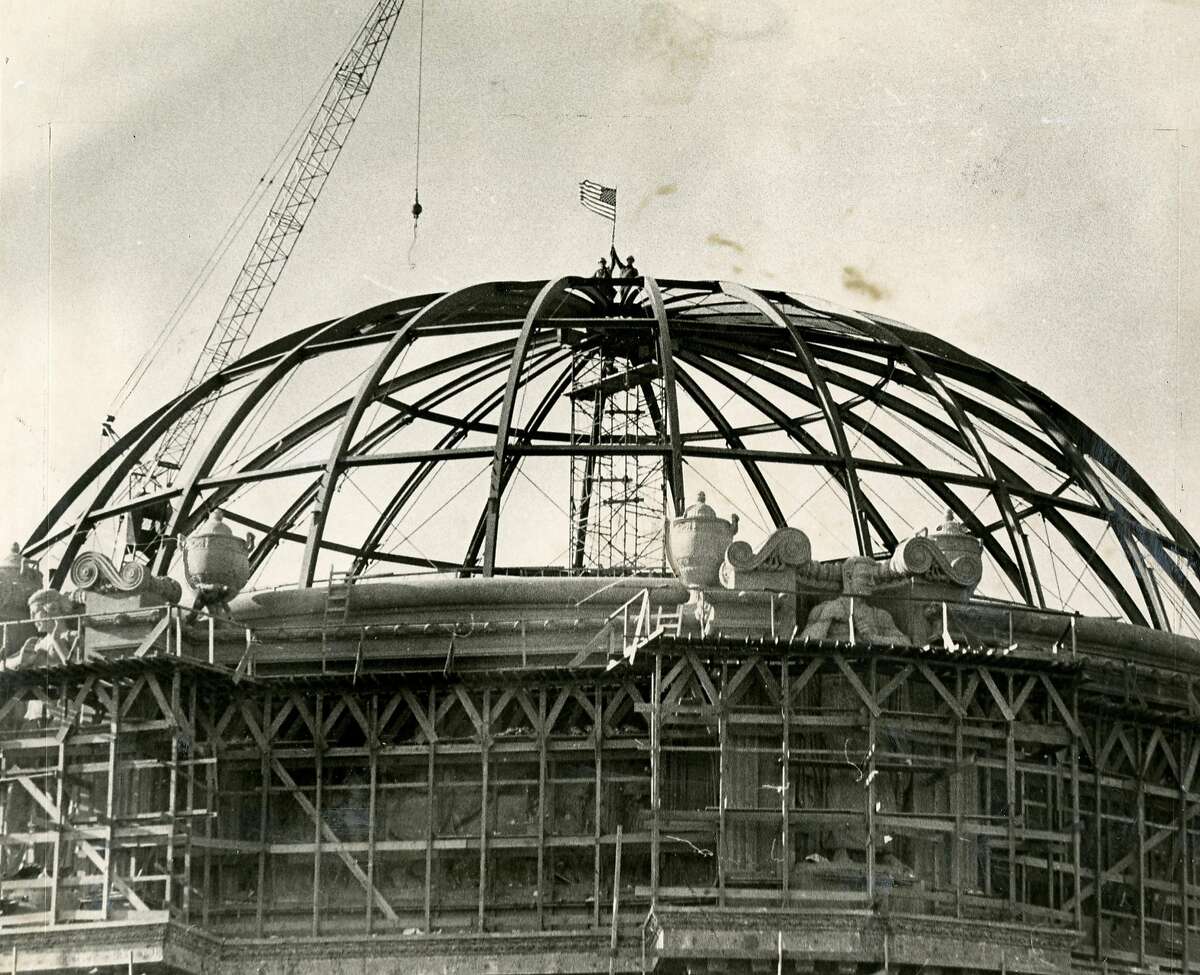 Steel topping shown during the reconstruction of the San Francisco Palace of Fine Arts. Steelworkers, Fred Anthony and Ron Jones (L-R) are shown atop the dome. December 22, 1966