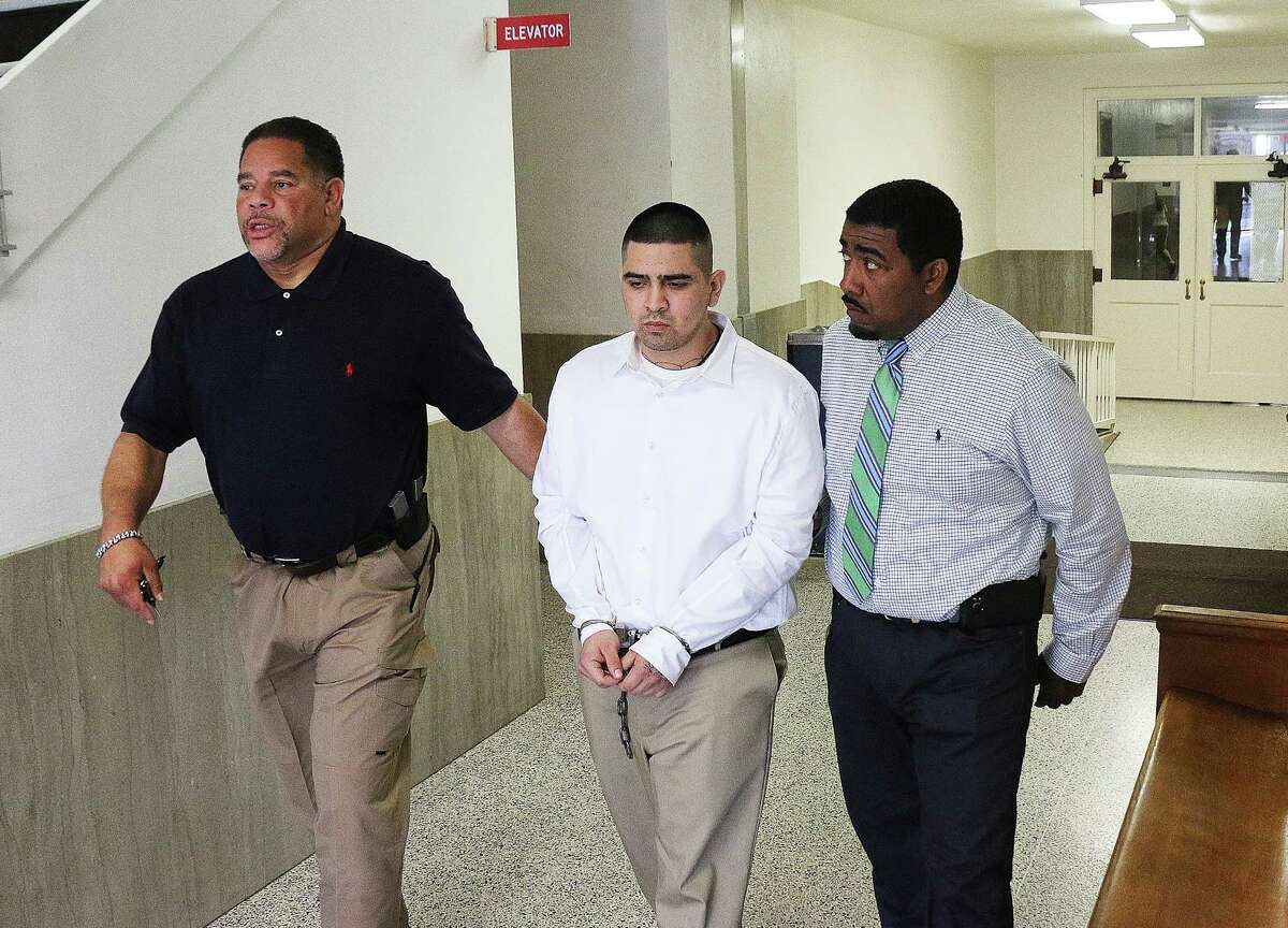 Roberto Ismael Alvarado Jr. is led away from the Liberty County Courthouse by Robert Harper and Chadwick Elmore, bailiffs for the 253rd State District Court. Alvarado was sentenced to 65 years in prison Wednesday for his part in the Dec. 16, 2015 murder of a convenience store clerk in Cleveland. Three other young men accused of participating in the crime have accepted plea agreements and are awaiting sentencing.