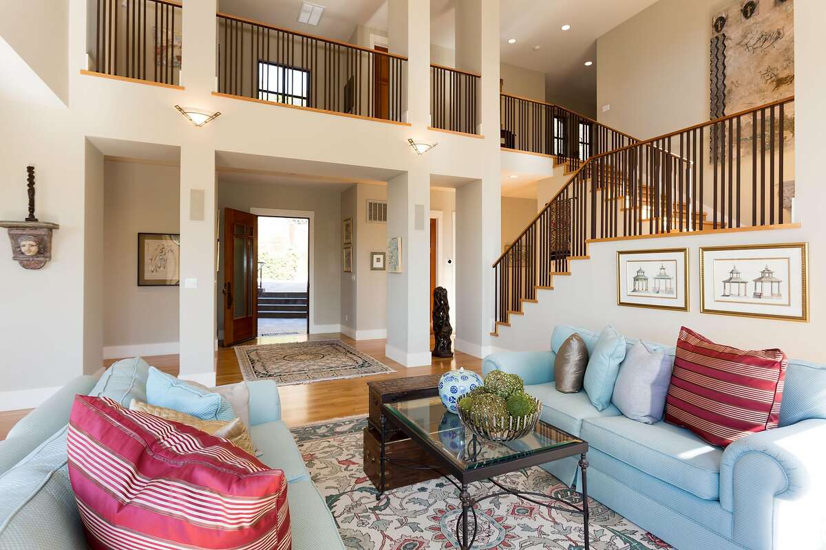 The palatial living room offers a double-height ceiling.