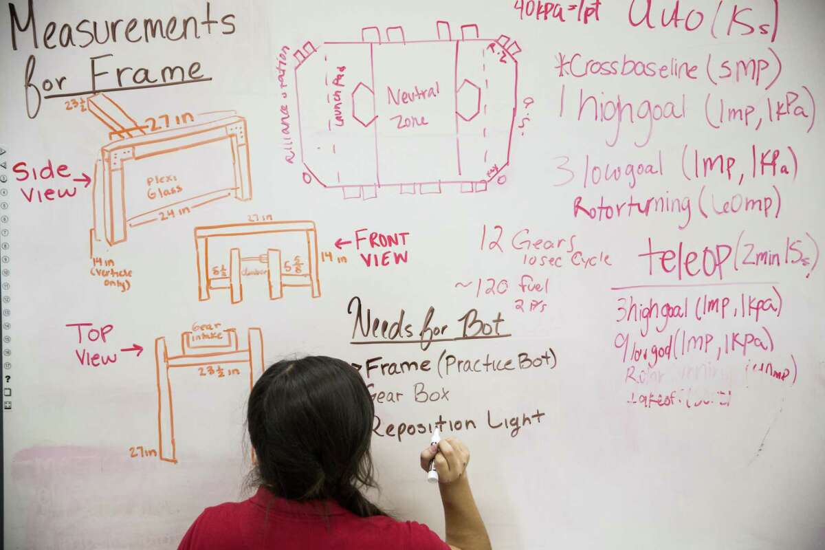 Gaby Garcia writes down what the team has left to do before competing while waiting to bag the Young Women's Leadership Academy's team robot at the Young Women's Leadership Academy in San Antonio, Texas on February 21, 2017.
