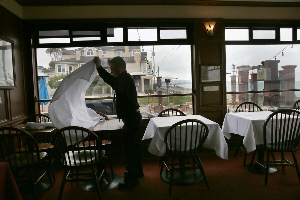 View of the outside as tables are being set for dinner at Miramar Beach restaurant on Wednesday, March 15, 2017, in Half Moon Bay, Calif.