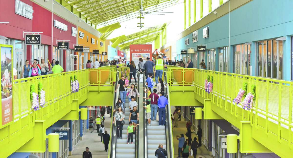 Shoppers explore the Outlet Shoppes on Thursday, March 16, 2017 as the stores open their doors to the public for the first time.