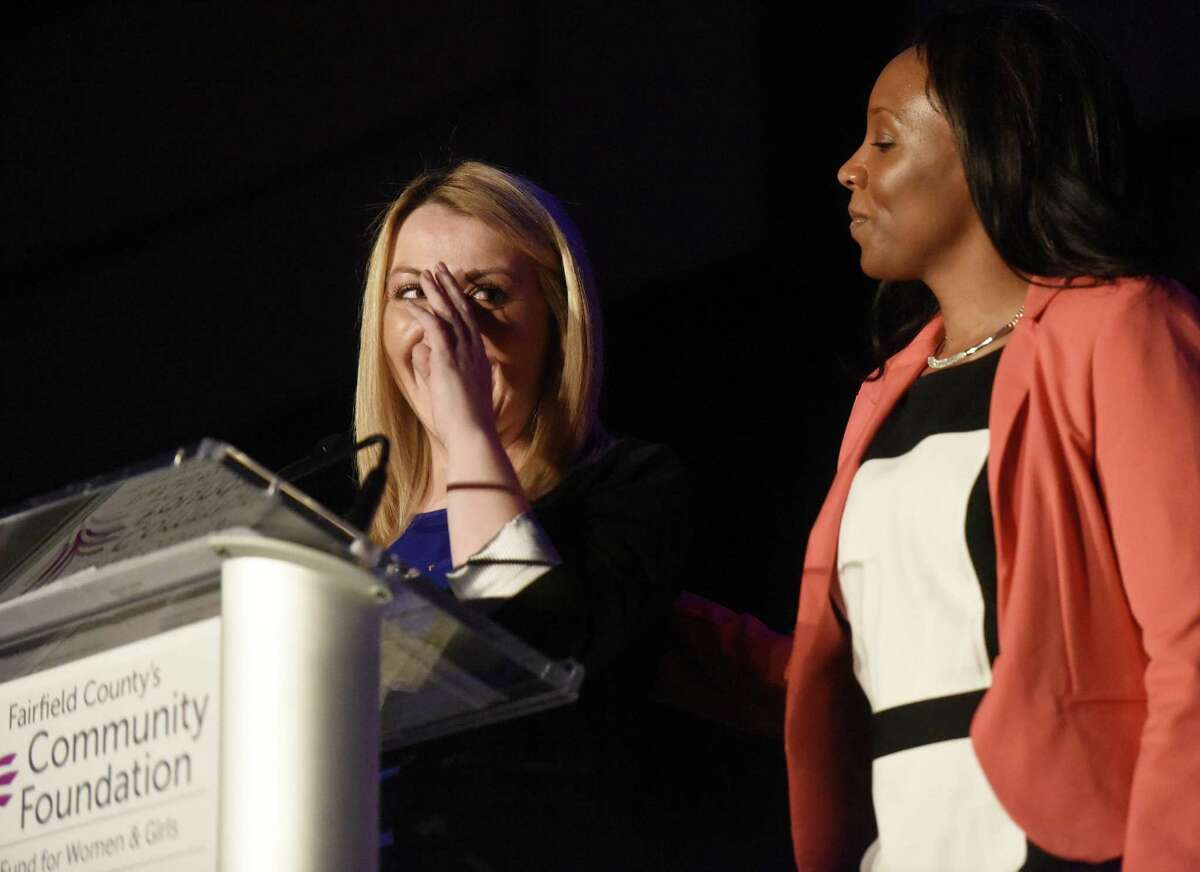 Family Economic Security Program (FESP) recipicent Heather Harrick, left, wipes away tears and is comforted by fellow FESP recipient Regina Scates while telling her story at Fairfield County's Community Foundation's Fund for Women and Girls Annual Luncheon at the Hyatt Regency ballroom in Old Greenwich, Conn. Thursday, April 7, 2016. Retired U.S. soccer player Abby Wambach then delivered the keynote presentation and answered questions to the luncheon's theme - the strength, resiliency and power of women and girls. She also addressed her recent driving under the influence arrest, which occurred Sunday, April 3 in Portland, Oregon.