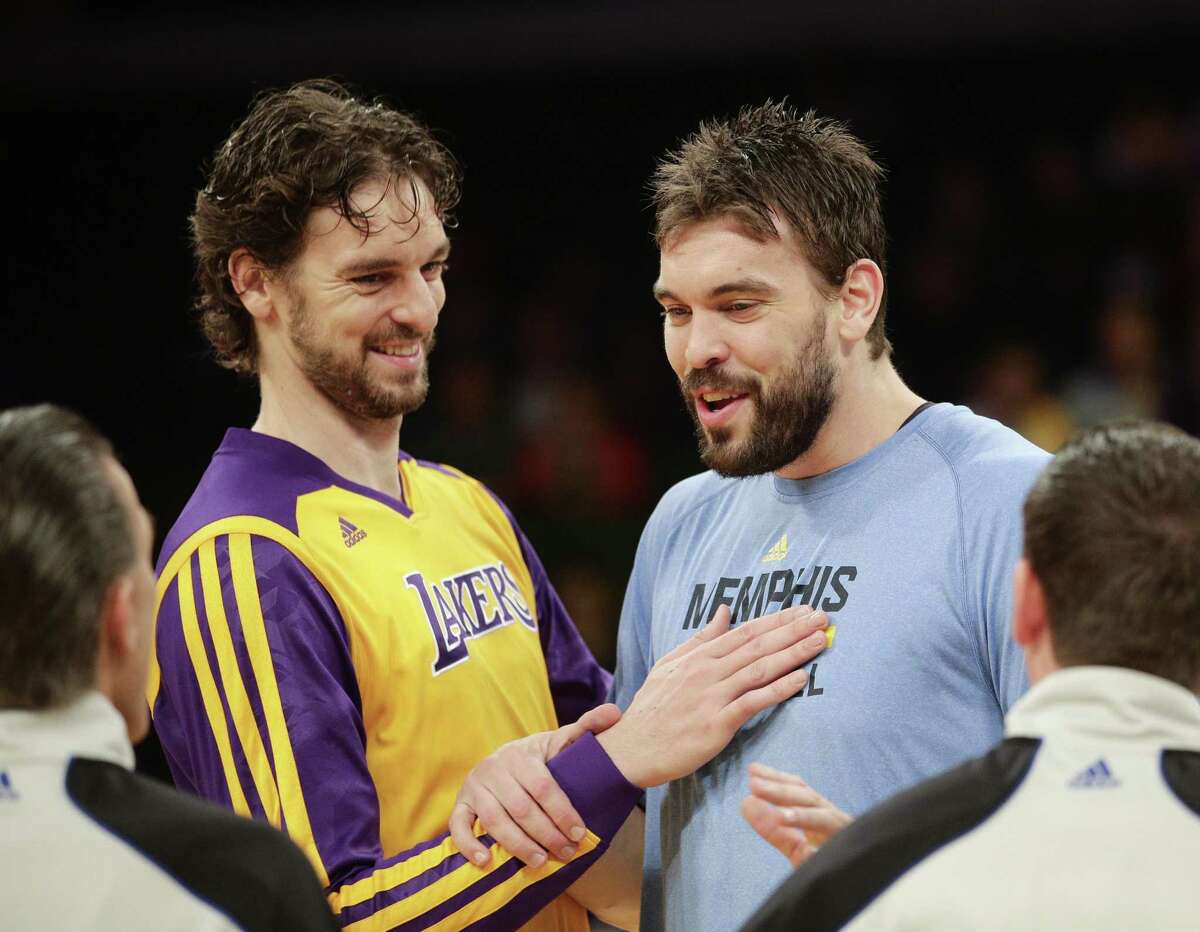 FILE - In this Nov. 15, 2013, file photo, Los Angeles Lakers' Pau Gasol, left, of Spain, and his brother, Memphis Grizzlies' Marc Gasol talk to referees before an NBA basketball game in Los Angeles. The NBA announces, Thursday, Jan. 22, 2015, the 10 players voted by fans to start in next month's All-Star game in New York, with brothers Pau and Marc Gasol in position to face each other after the last update. (AP Photo/Jae C. Hong, File)