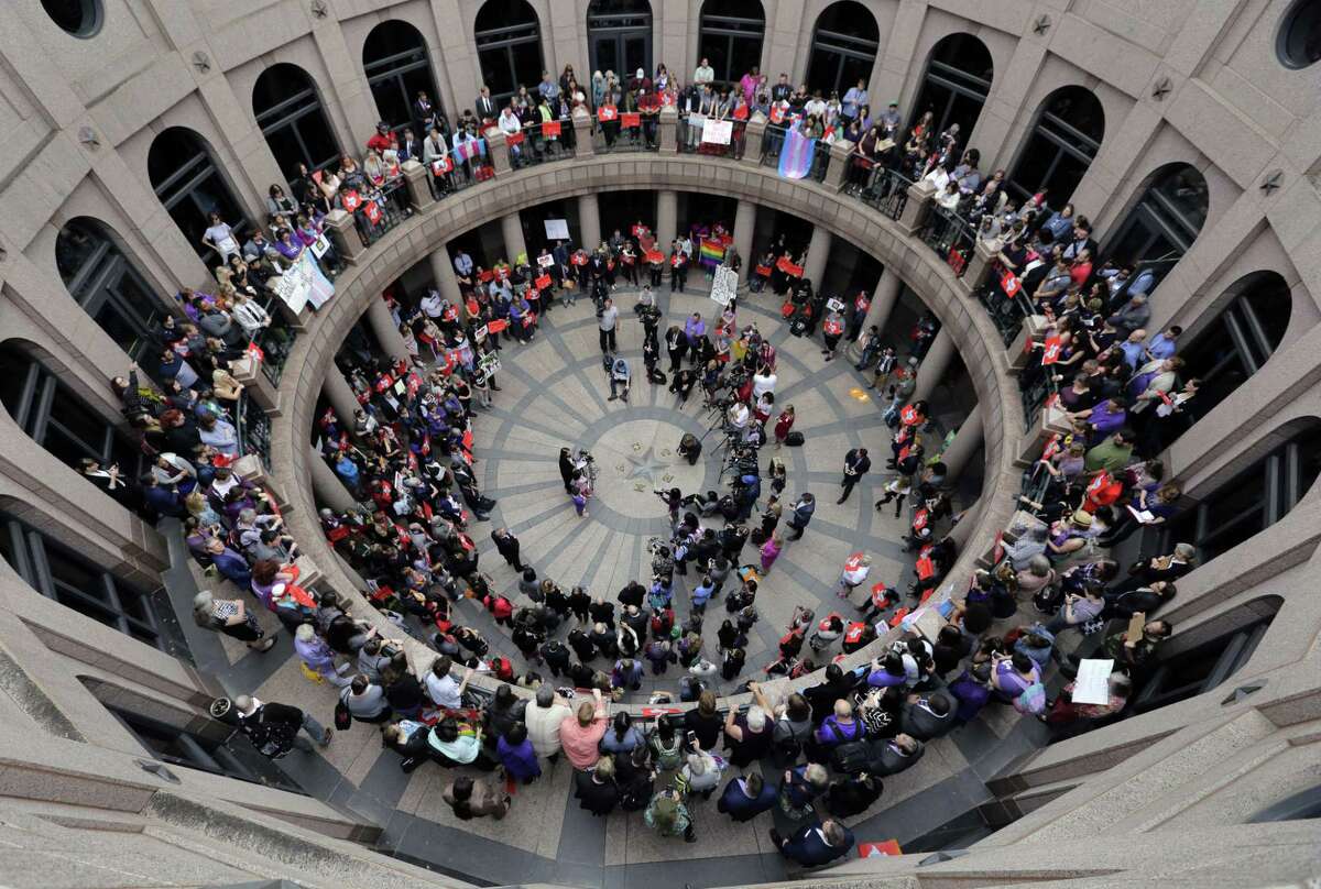 Members of the transgender community and others who oppose Senate Bill 6 protest in the exterior rotunda at the Texas state Capitol as the Senate State Affairs Committee holds hearings on the bill March 7.