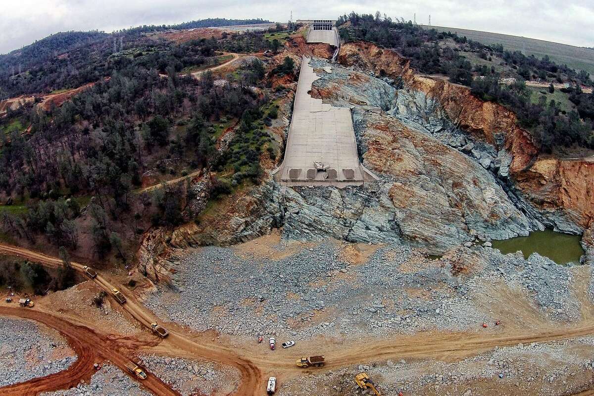 The damaged main spillway of the Oroville Dam is seen as officials continue to work on clearing debris from the bottom on Friday, March 3, 2017, in Oroville, Calif.