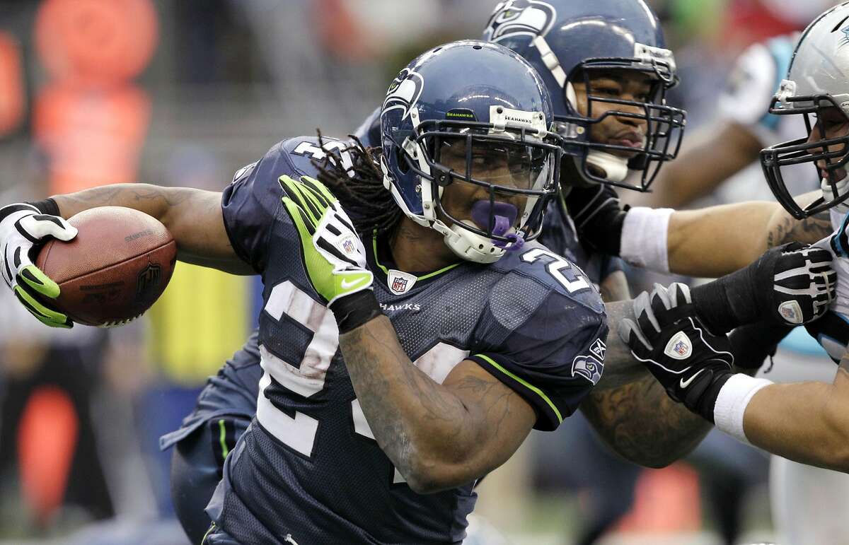Seattle Seahawks' Marshawn Lynch (24) rushes against the Carolina Panthers in the second half of an NFL football game, Sunday, Dec. 5, 2010 in Seattle. Keep clicking to see more photos of Lynch during his retirement. 