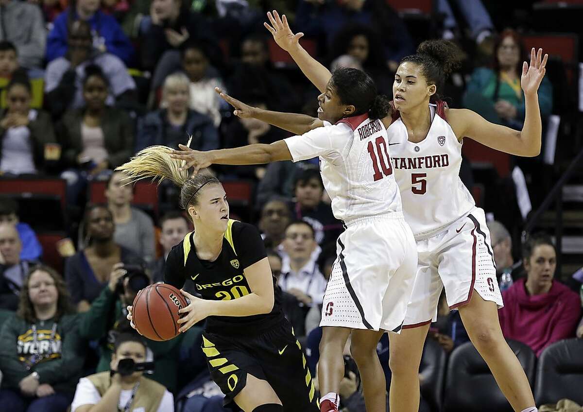 Stanford's Kaylee Johnson (5) and Briana Roberson (10) defend Oregon's Sabrina Ionescu during the second half of an NCAA college basketball game in the Pac-12 tournament, Saturday, March 4, 2017, in Seattle. (AP Photo/Elaine Thompson)