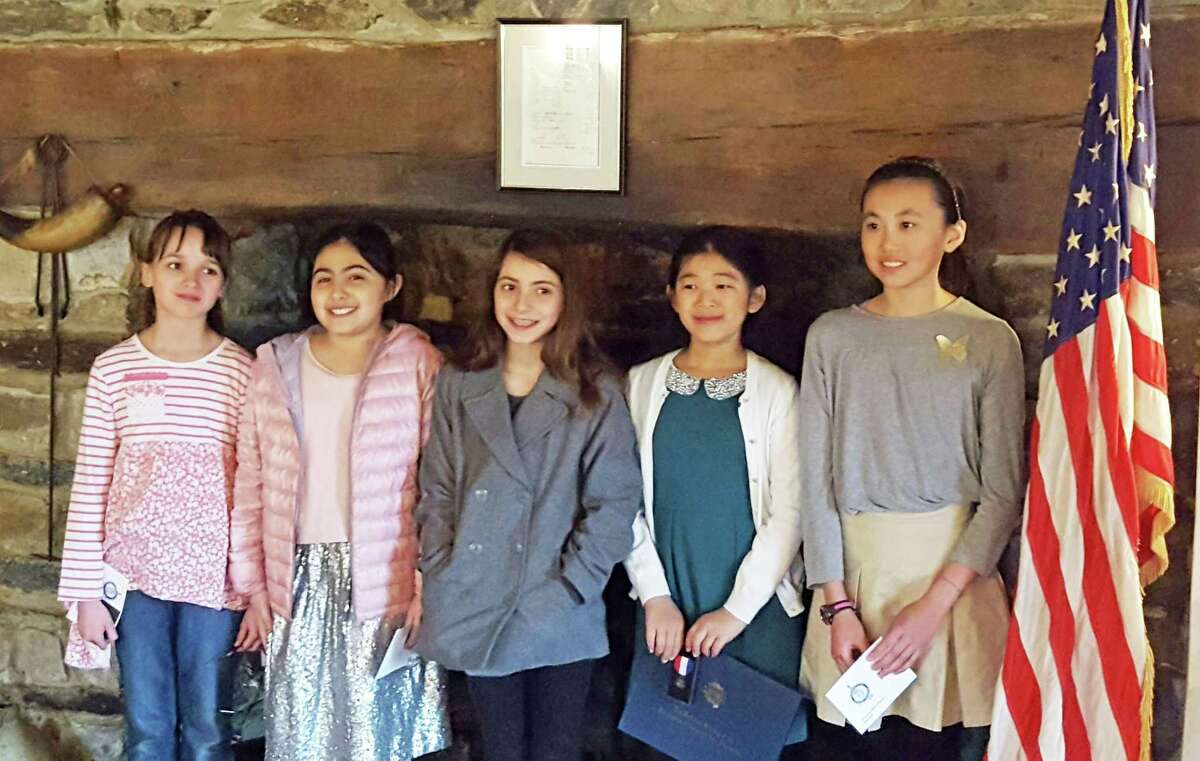 From left, fifth-graders Elizabeth Flintoff, Sahar Shakib, Alessia Cheisara and Annabel Zho were among the winners and runners up for the annual DAR essay contest. Annabel won first place in her category.