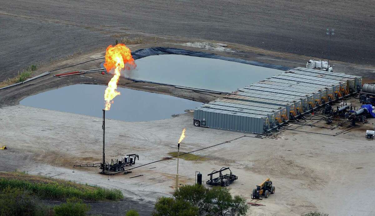 Water retention ponds are seen behind a gas flare, also known as a flare stack, in a Dec. 13, 2013, aerial picture taken in the Eagle Ford Shale region near Karnes City.