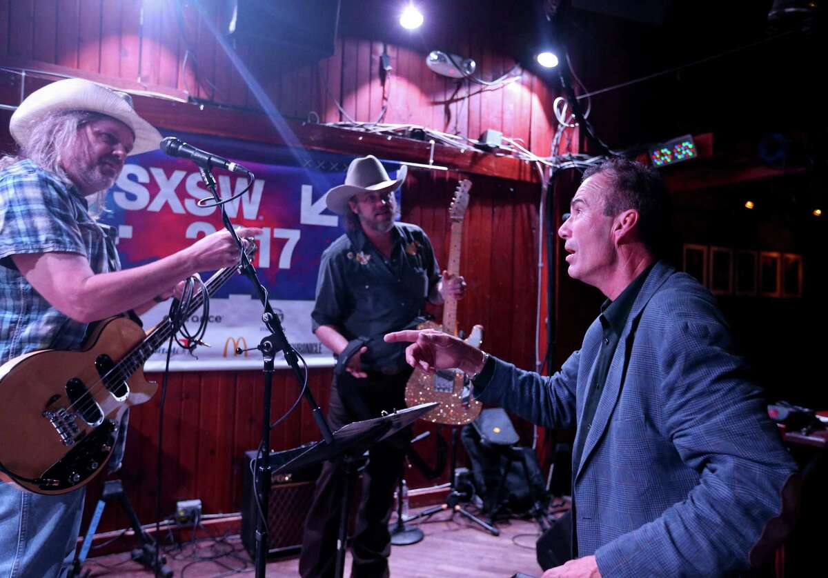 Neal Walker (from left), Cody Richardson, and Joe Minus talk after the Rich Minus tribute held Friday March 17, 2017 at the Saxon Pub in Austin,Tx., during SXSW.