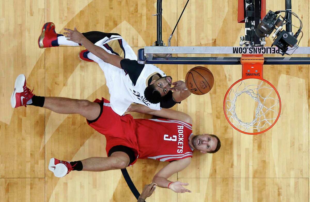 New Orleans Pelicans forward Anthony Davis goes to the basket as Houston Rockets forward Ryan Anderson (3) falls to the court during the first half of an NBA basketball game in New Orleans, Friday, March 17, 2017. (AP Photo/Gerald Herbert)