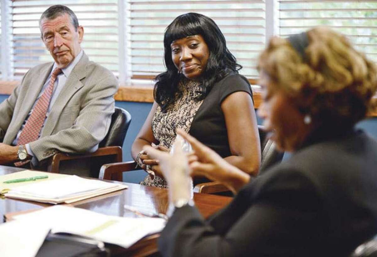 In this file photo, former NEON board member Brian Baxensdale and interim chief of staff Chiquita Stephenson listen as the interim NEON CEO and president speaks during an editorial board meeting.