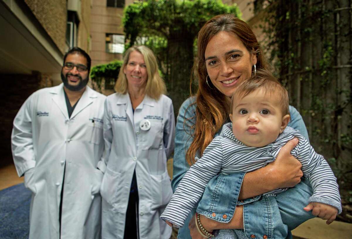 Ana Carla Cepeda holds her 6-month-old son, Bruno, in front of Dr. Anuj Suri, left, and Dr. Barbara Held at Houston Methodist Hospital Texas Medical Center.