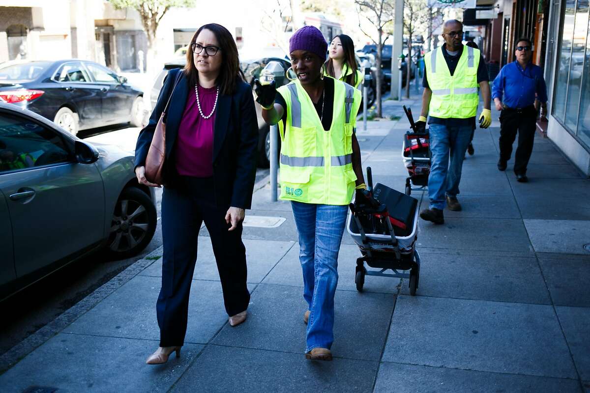 Safonya Crawford, center, shows Fix-It Director, Sandra Zuniga, left, areas of issues on 9th Avenue in San Francisco, Calif. Friday, March 17, 2017.