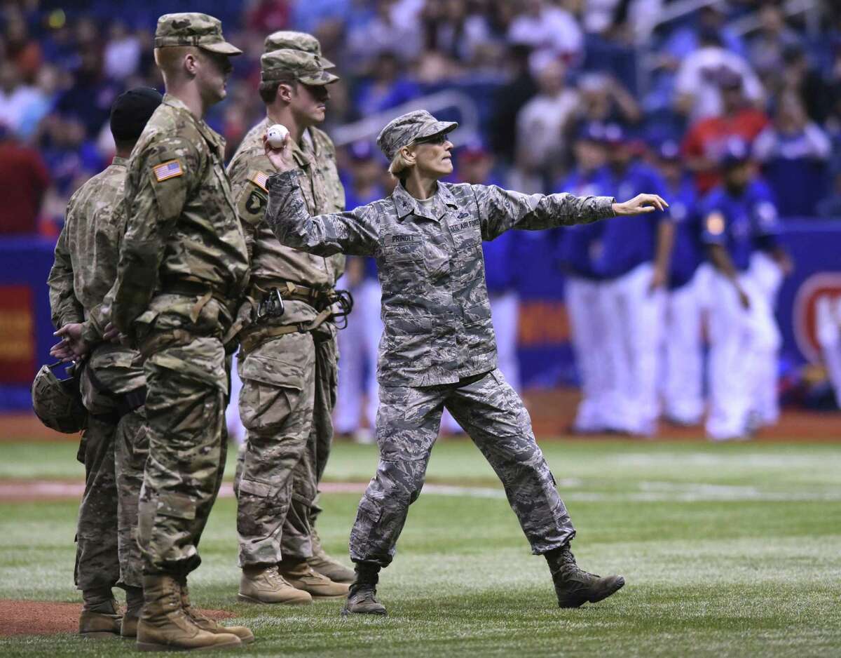 Brigadier General Heather L. Pringle, Commander of the 502nd Air Base Wing and Joint Base San Antonio, throws out the first pitch of the second game of Big League Weekend, between the Cleveland Indians and the Texas Rangers, in the Alamodome on Saturday, March 18, 2017.
