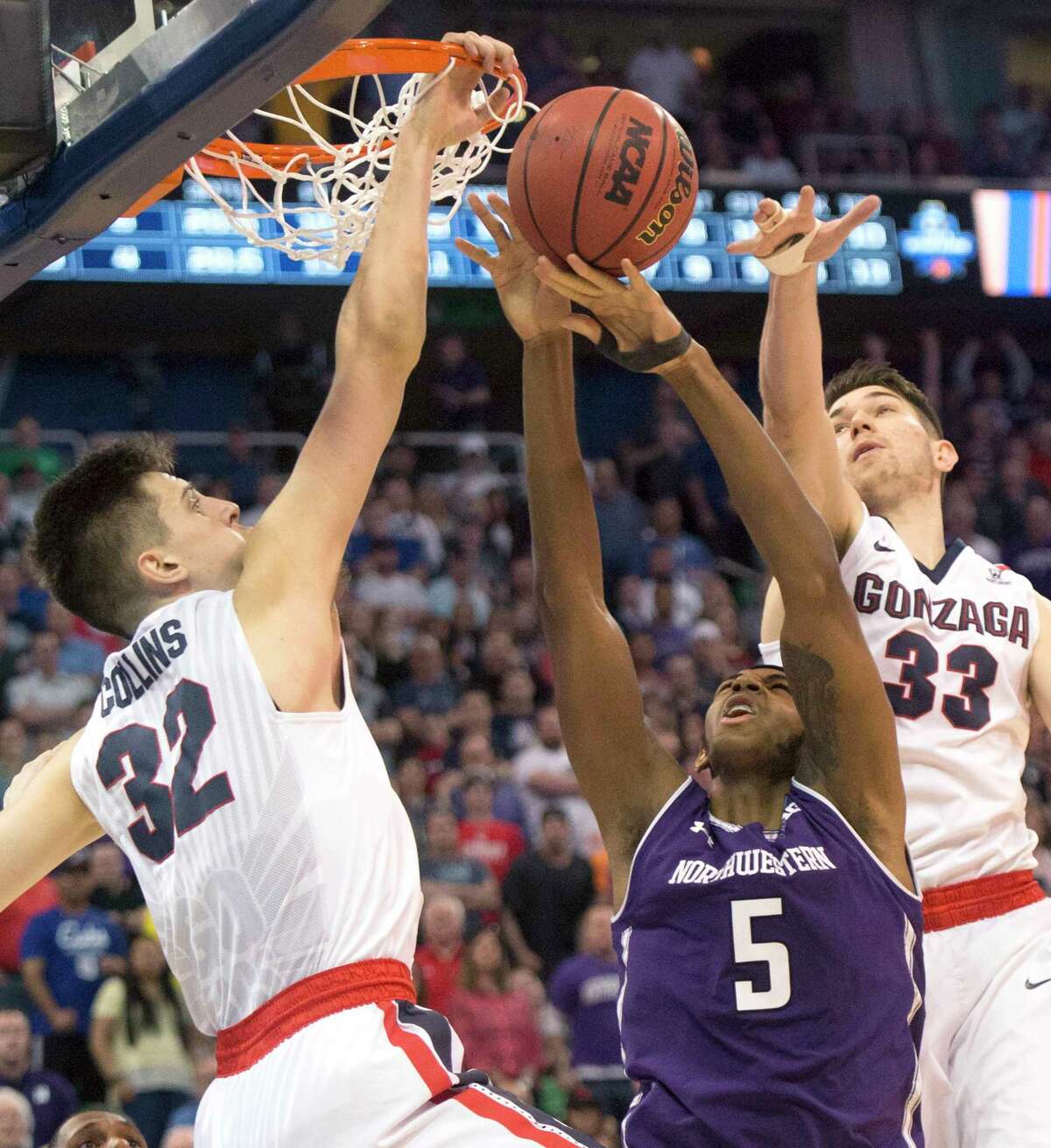 Gonzaga forward Zach Collins sticks his hand through the hoop to punch out a shot by Northwestern center Dererk Pardon, and he got away with it.
